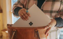 woman putting laptop in bag