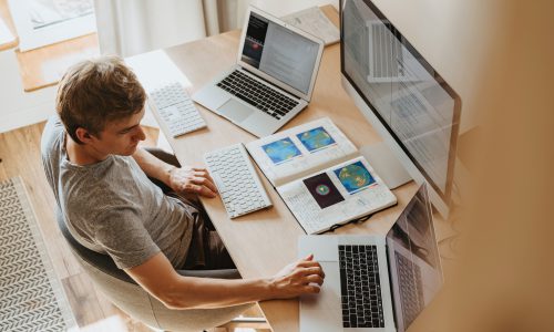 man at two computers