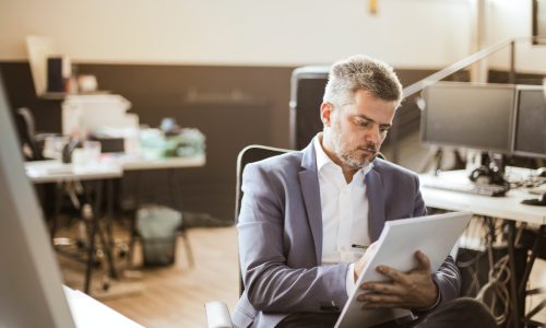 man writing on notepad